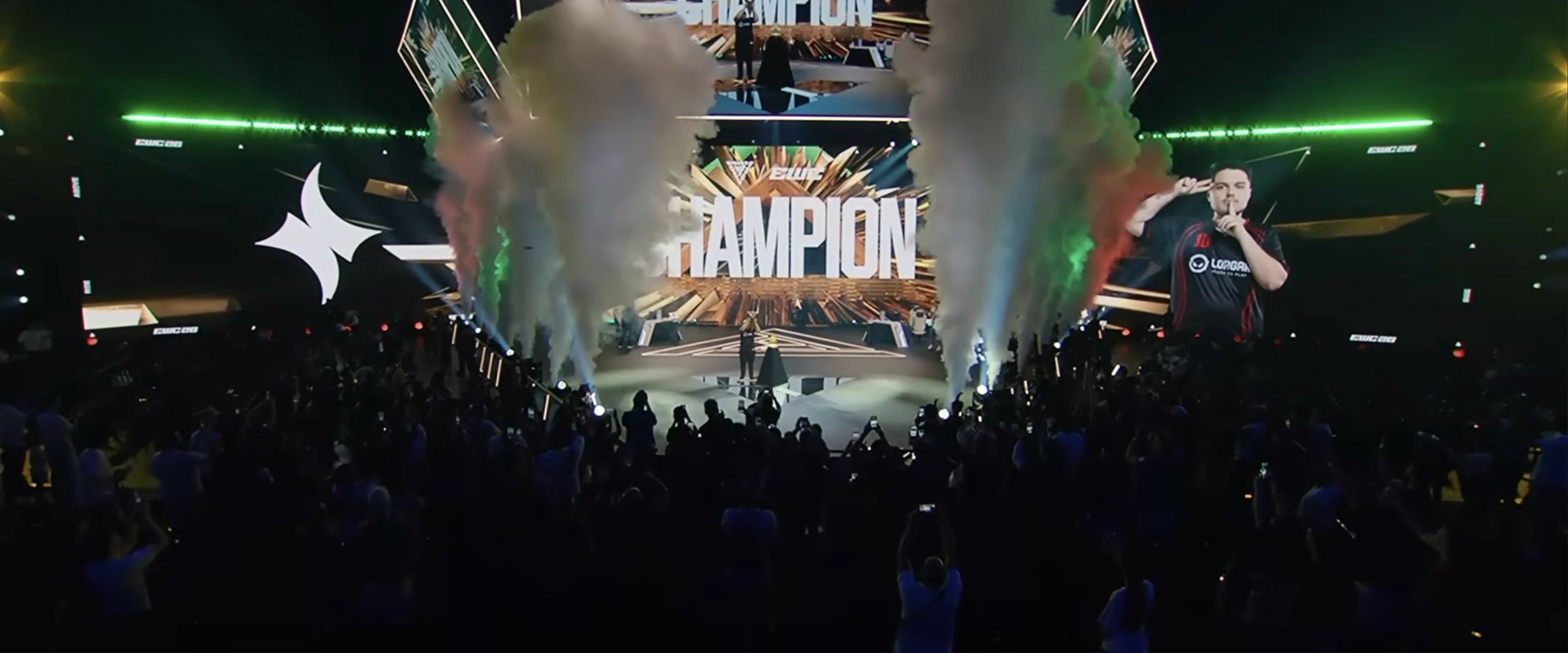 The crowd at the Esports World Cup 2026 arena in front of screens reading CHAMPION