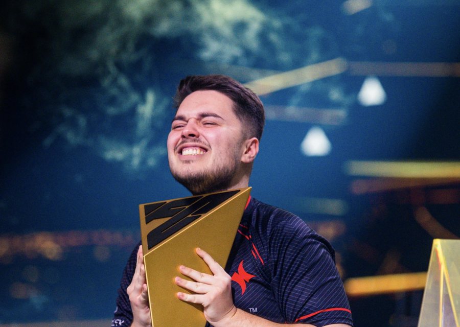 The world champion with the trophy on the Esports World Cup stage in Paris