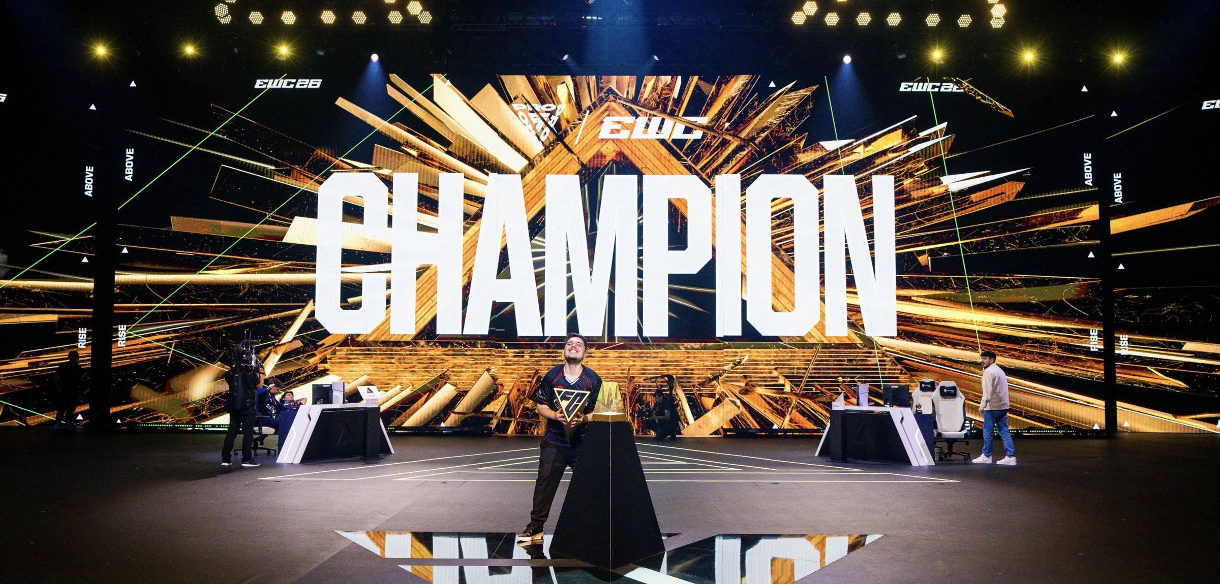 The main stage of the Esports World Cup 2026 in Paris with CHAMPION on the screen and a player in the spotlights