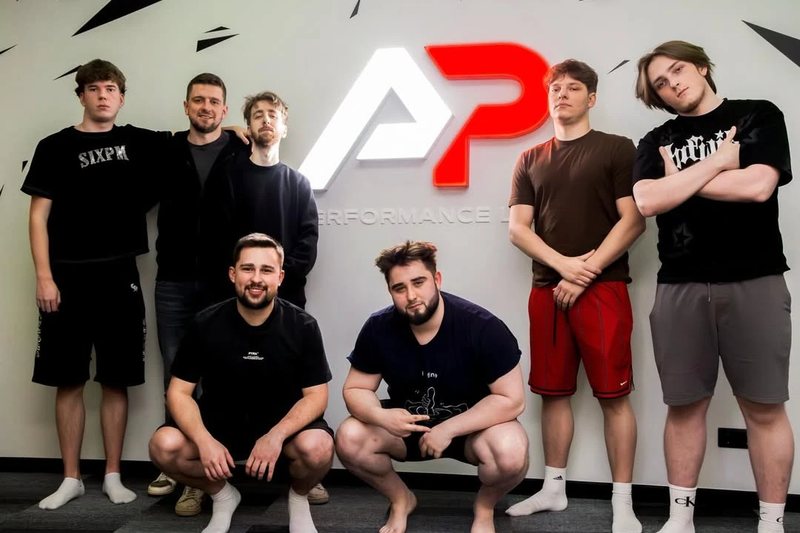 A team posing under the A&P Performance Lab logo in Riga